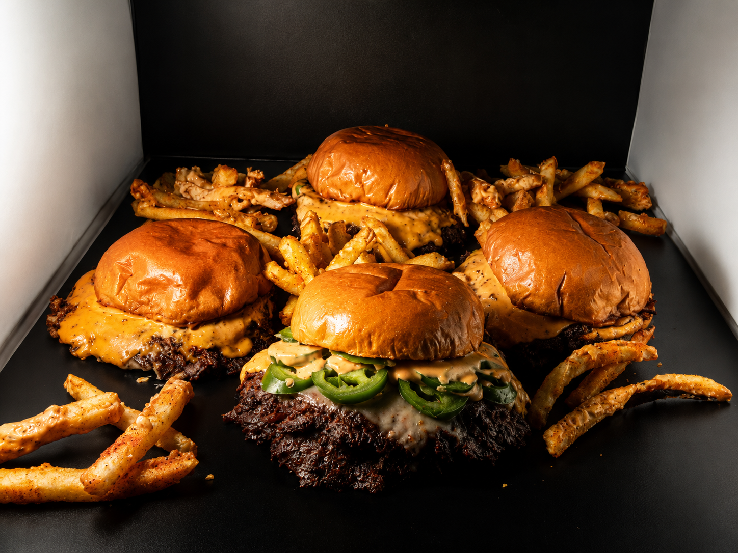 Gotham Halal catering trays of smash burgers and loaded fries